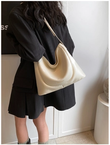 Detail of a beige PU leather hobo bag with Fashion & Bags text on a shoulder model
