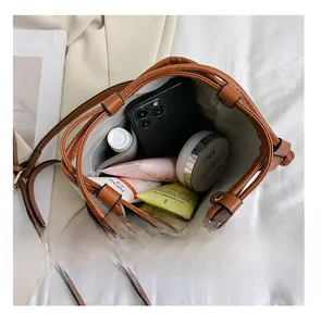 Interior view showing the large capacity and zipper pocket of this contrast bucket bag