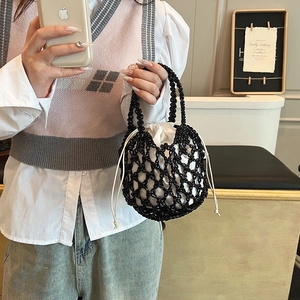 Detail of hand-woven black mesh bucket bag with white drawstring liner and rope handle