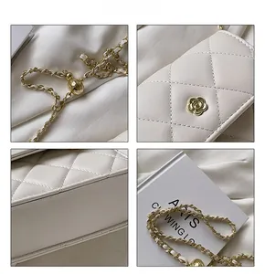 Detail view of cream quilted bag with gold camellia clasp and chain strap