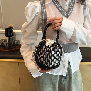 Detail of hollow woven cotton mesh bag with white drawstring lining and sturdy handle