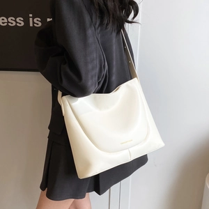 Minimalist ivory PU leather tote bag for women with gold lettering on wide shoulder strap