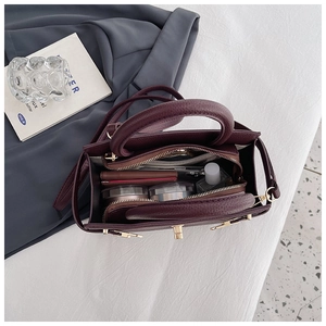 Internal view of burgundy leather handbag showing large capacity and multi-compartment design