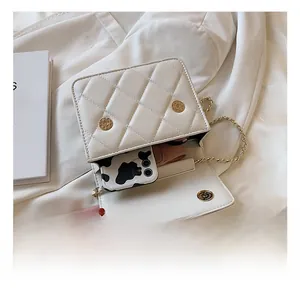 Top view of white quilted chain bag showing interior capacity for phone and wallet