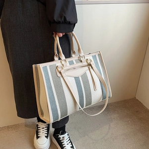 Large striped canvas tote bag with faux leather trim and shoulder strap for daily use