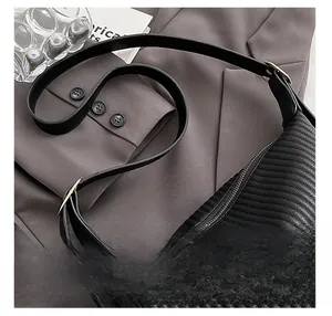 Detail showing pleated black faux leather texture with elegant gold adjustment buckle
