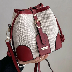 Retro canvas and leather bucket bag in cream and dark red with adjustable strap