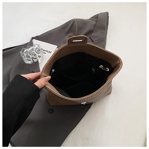 Detail of interior storage with zipper pocket in a brown pleated shoulder bag