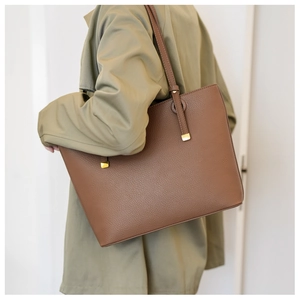 Vue détaillée du sac cabas en cuir marron grainé avec boucles élégantes en métal doré