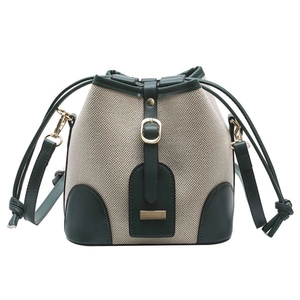 Contrast canvas bucket bag with green leather trim and drawstring for women