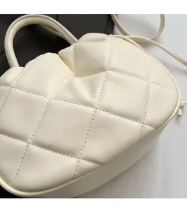 Detail view of cream quilted PU leather handbag with elegant diamond stitching pattern