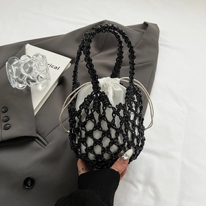 Close-up of black hollow woven tote bag with a white canvas drawstring inner liner