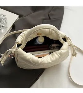 Interior view showing the storage capacity of this white quilted drawstring bucket bag