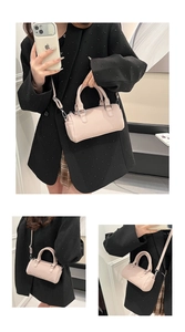 Detail of light pink pleated Boston bag with twin handles and detachable strap