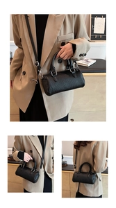Detail view of black pleated Boston bag showing handheld, crossbody, and shoulder strap styles