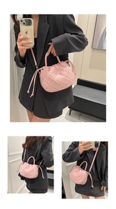 Close-up of pink quilted cloud bag featuring drawstring closure and PU leather texture
