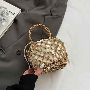 Detail of gold metallic hollow knit tote bag with white drawstring inner pouch for travel