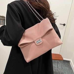 Pink corduroy crossbody bag with vertical pleated texture and metal chain strap