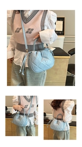 Detailed views of light blue quilted bucket bag showing hand-carry and crossbody styles
