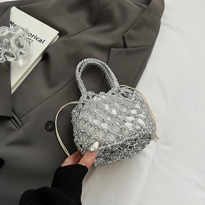 Detail of silver woven mesh tote bag with white drawstring liner on grey suit fabric