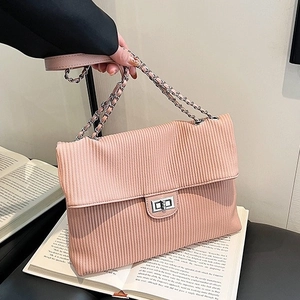 Pink corduroy crossbody bag with vertical texture and silver metal chain strap