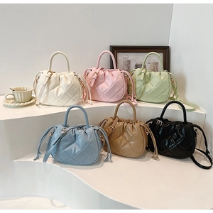 Quilted rhombus bucket bags displayed in white pink green blue brown and black colors