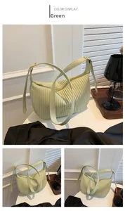 Detail of mint green pleated PU leather bag with adjustable strap and metal zipper