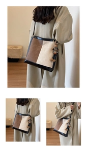 Detail of a large capacity bucket bag with color-block design and cute bunny pendant charm