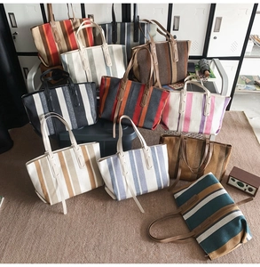 Various striped canvas tote bags featuring leather handles and spacious interior design