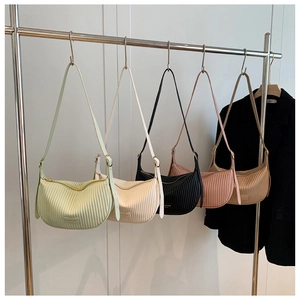 Detailed row of pleated hobo bags in assorted colors with adjustable shoulder straps