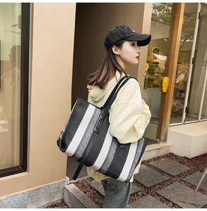 Detailed view of the large striped canvas tote bag showing thick texture and black strap
