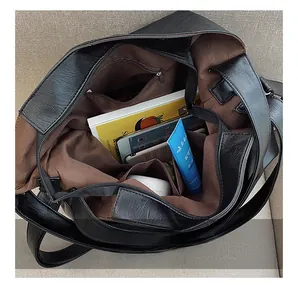 Interior view of large black lychee faux leather tote showing spacious multi-layer storage