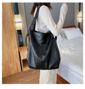 Detail of black large capacity hobo tote bag in premium pebbled faux leather material