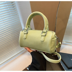 Detail of light green Boston bag with vertical stripe embossing and silver hardware