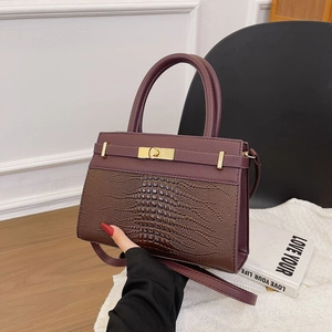 Elegant burgundy crocodile-textured leather handbag with gold twist lock and shoulder strap