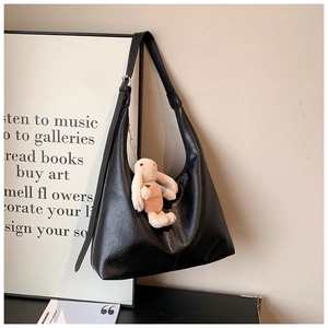 Large black shoulder tote bag in matte faux leather with plush rabbit pendant