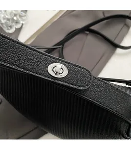 Detailed close-up of premium black lychee texture leather with silver twist lock closure