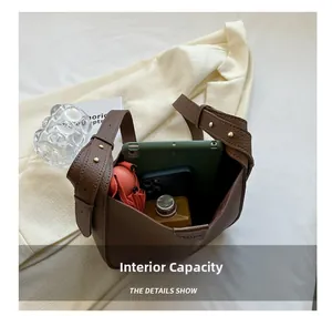 Interior view of brown leather bucket bag showing capacity for iPad, phone and umbrella