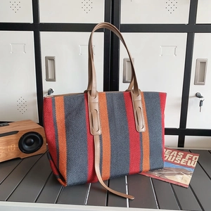 Large striped canvas tote bag with red, blue, and orange vertical stripes and leather handles