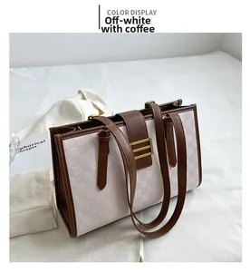 Detail of cream tote bag featuring coffee brown straps and embossed checkerboard pattern