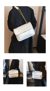 Detailed close-up of white quilted leather chain bag with elegant V-pattern and gold hardware