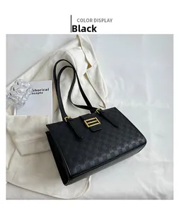 Close-up of black waffle textured tote bag with golden metal buckle on white background