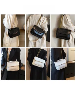 Detail of quilted chain bag shown as shoulder and crossbody bag in black and white