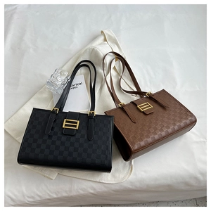 Detailed close-up of checkered embossed tote bags in black and brown with metal buckles