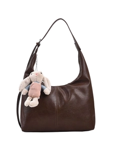 Brown faux leather hobo tote bag with vertical stitching and cute plush bunny charm