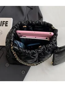 Quilted tote bag with gold chain showing large capacity for tablet and daily items
