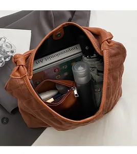 Internal view of brown quilted hobo bag showing large storage capacity for daily essentials