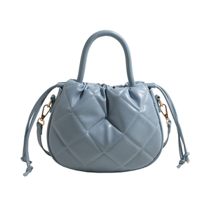 Quilted light blue PU leather handbag with elegant crossbody strap and top-handle design