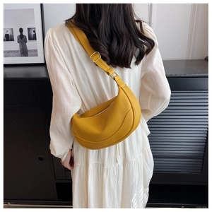 Detail of yellow crescent shoulder bag in pebble leather with adjustable strap and gold hardware