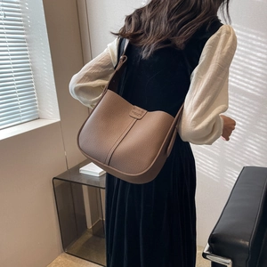 Detail view of the brown lychee pattern leather shoulder bag with fine saddle stitching